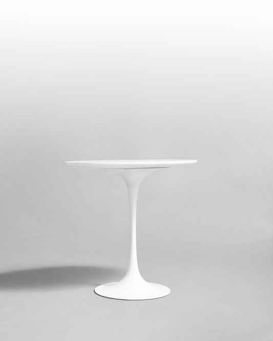 Arkana side table designed by Maurice Burke in the 1960s, featuring a white tulip base and minimalist design, inspired by the mid-century modern era and the work of Eero Saarinen.