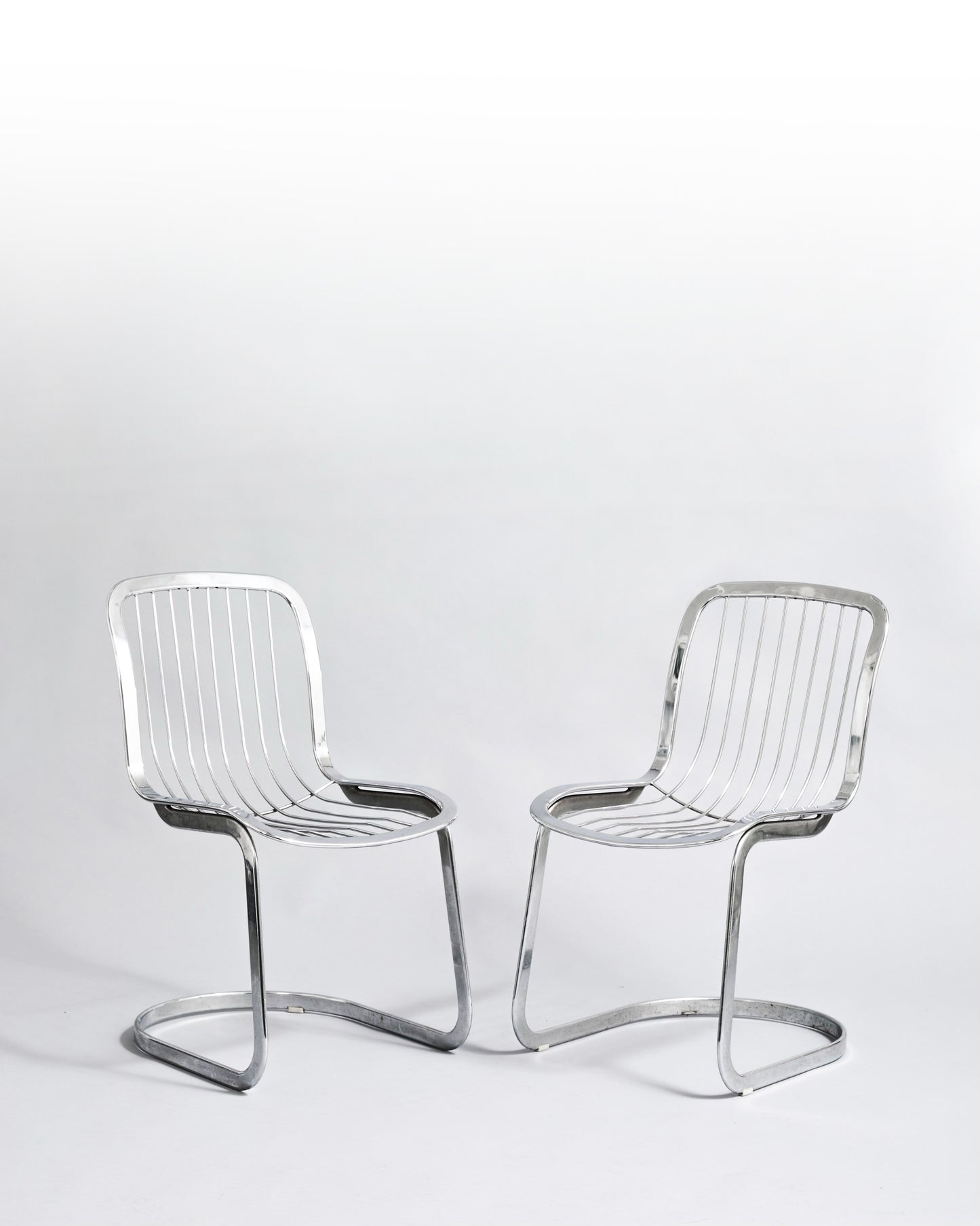 Pair of vintage cantilever chairs designed by Willy Rizzo for Cidue, crafted in chromed metal, embodying 1970s Hollywood Regency style.