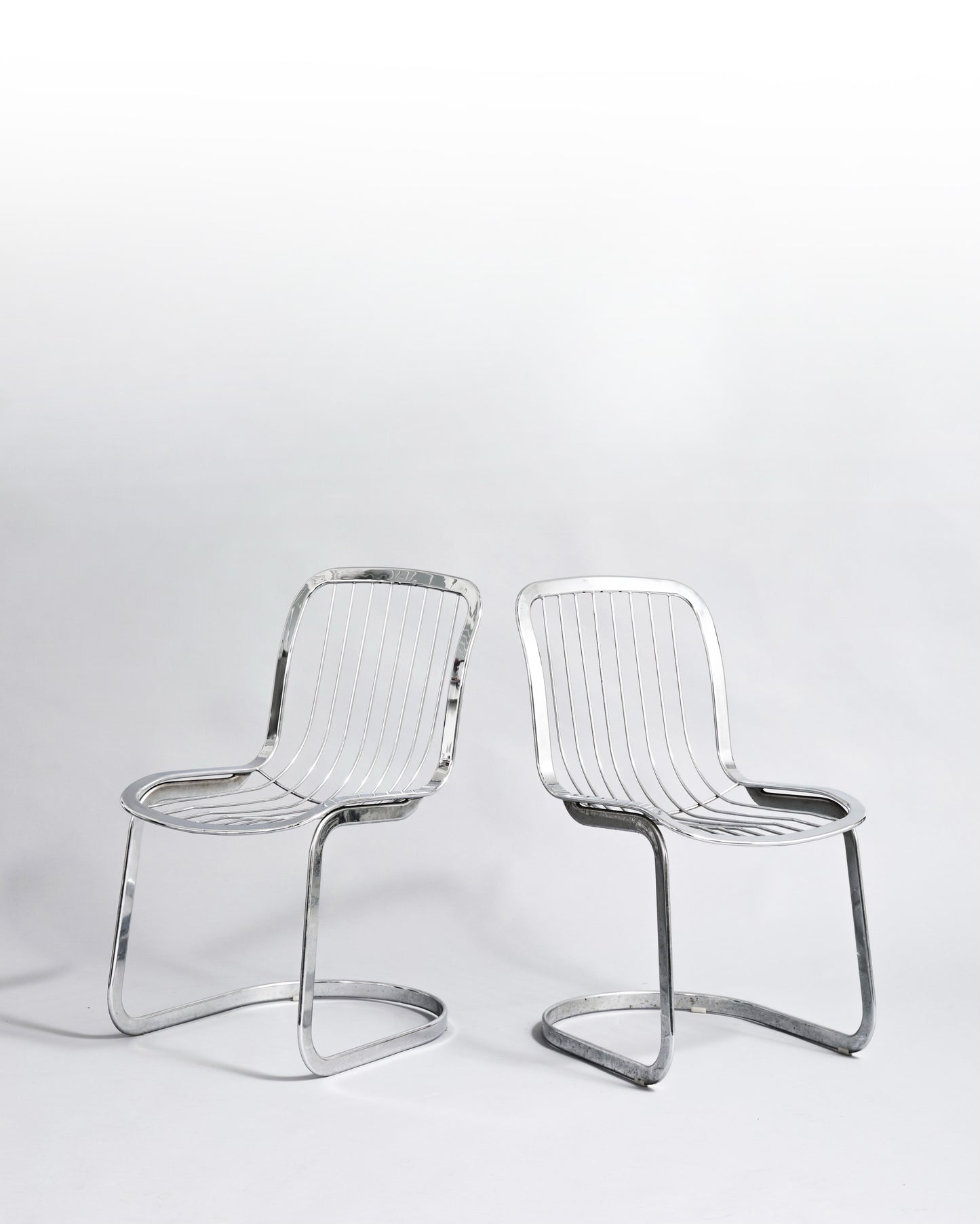 Pair of vintage cantilever chairs designed by Willy Rizzo for Cidue, crafted in chromed metal, embodying 1970s Hollywood Regency style.