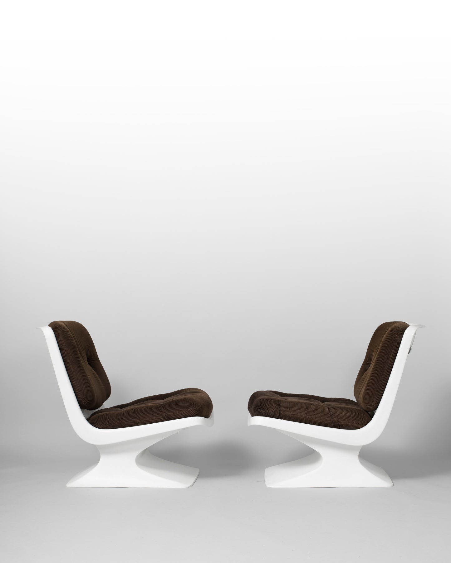 Pair of vintage lounge chairs designed by Albert Jacob for Grosfillex in the 1970s, featuring sculptural PVC frames and brown cushioned seats, embodying bold mid-century modern design and avant-garde aesthetics.